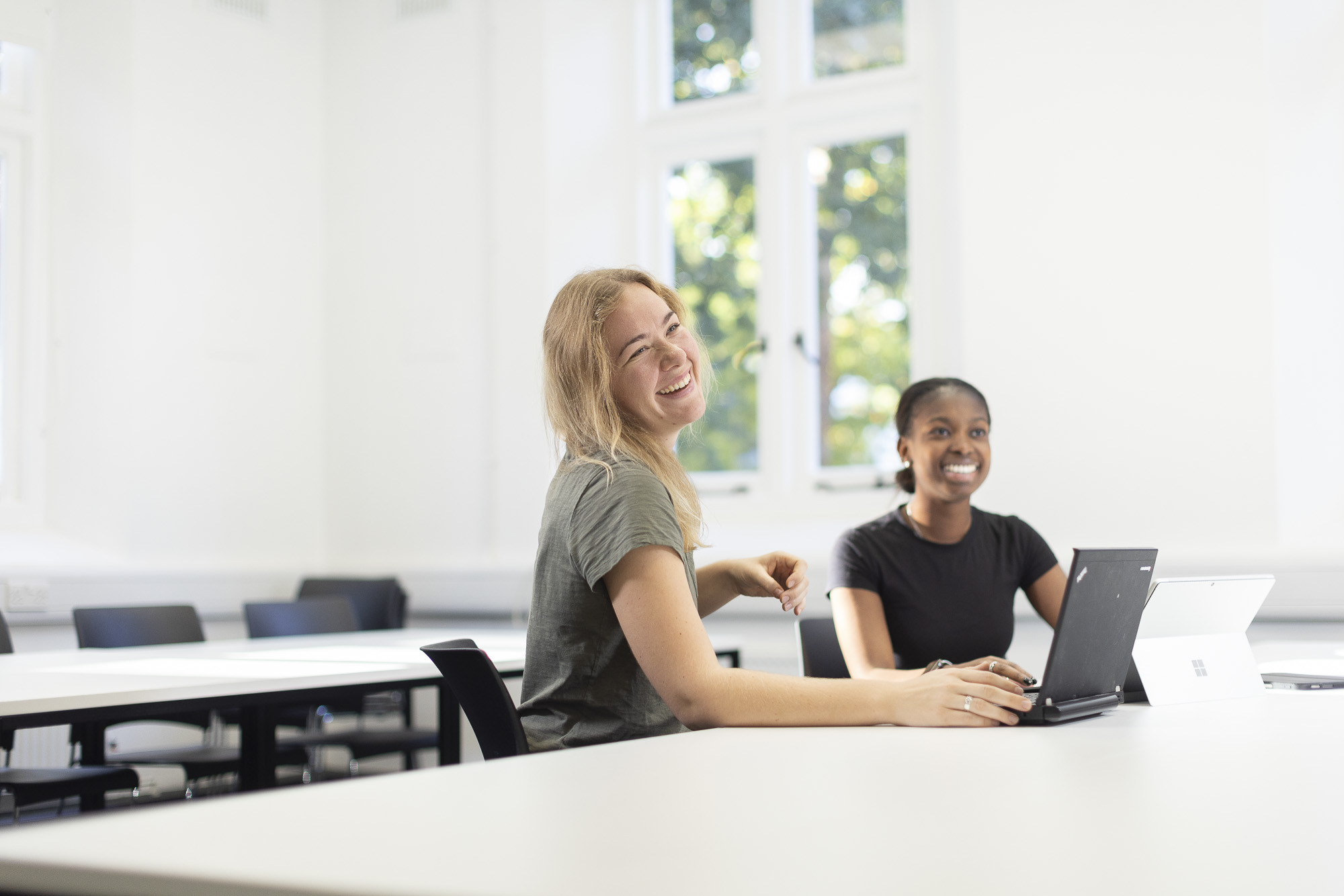 Two students working together and laughing