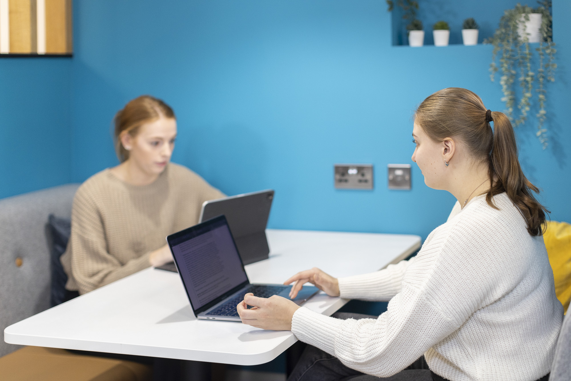 Two female students studying with laptops in Cavendish House