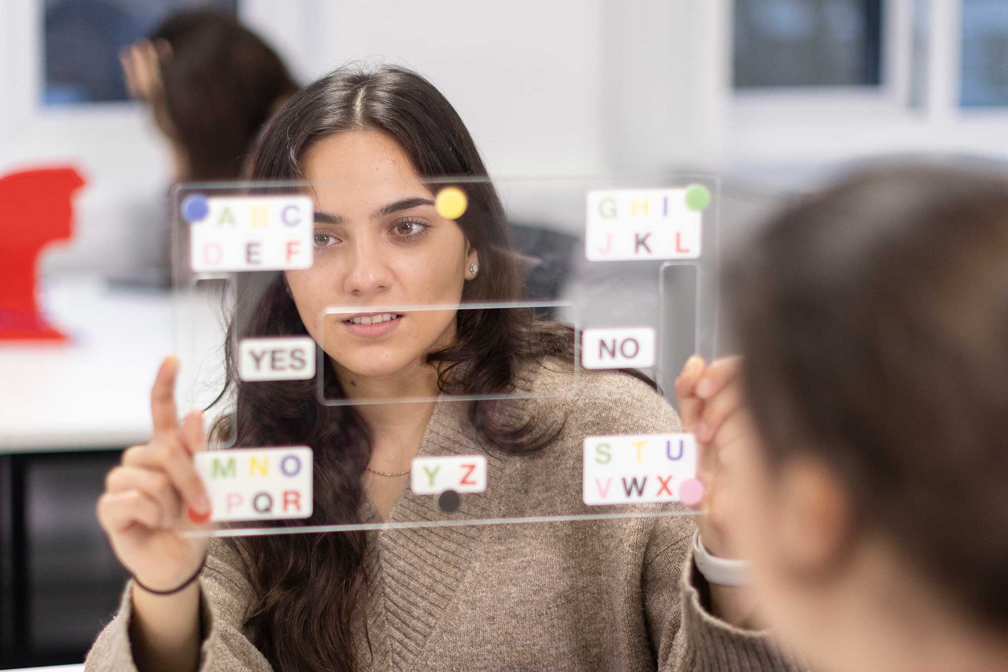 SaLT student using a piece of equipment to communicate