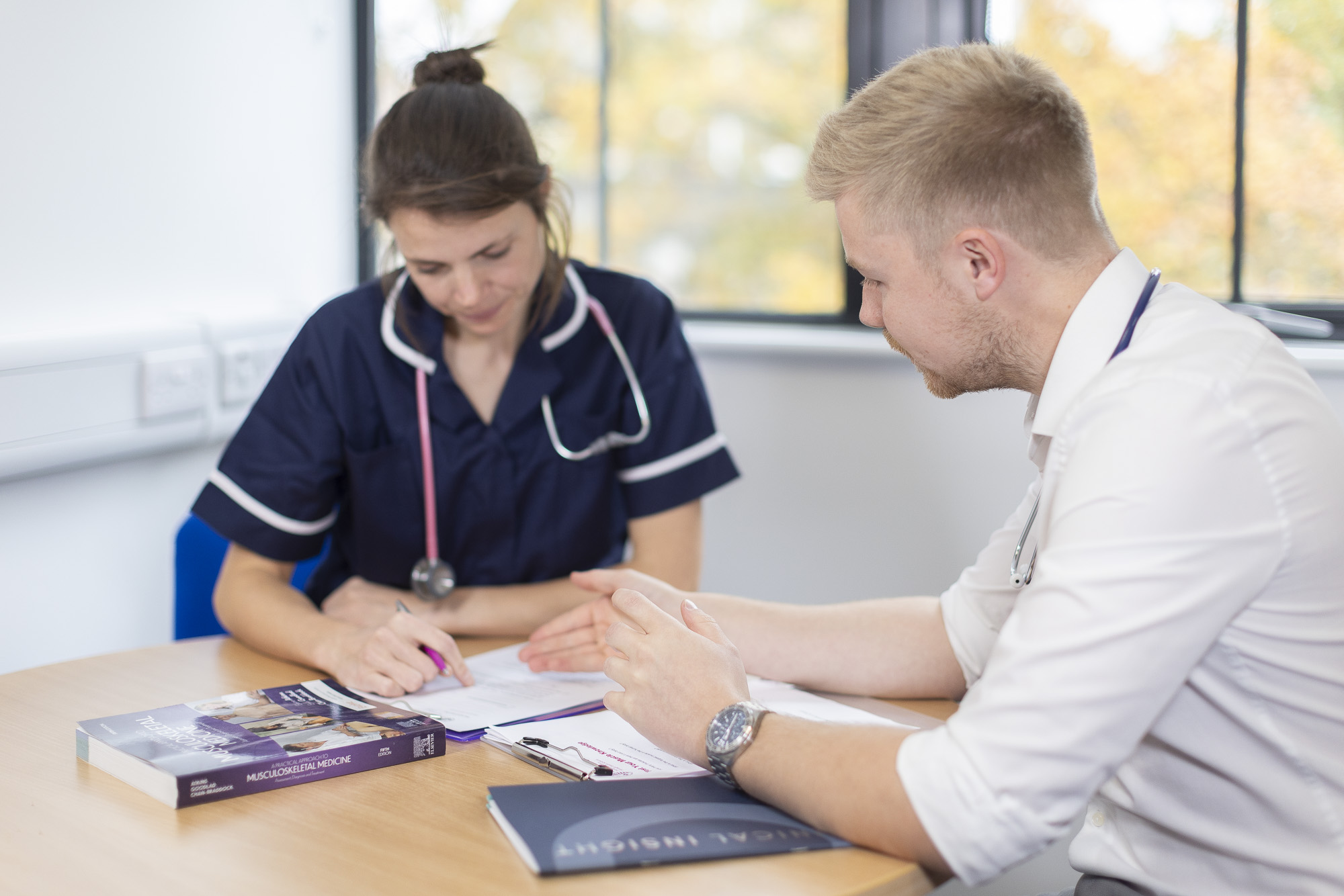 Two medical staff speaking