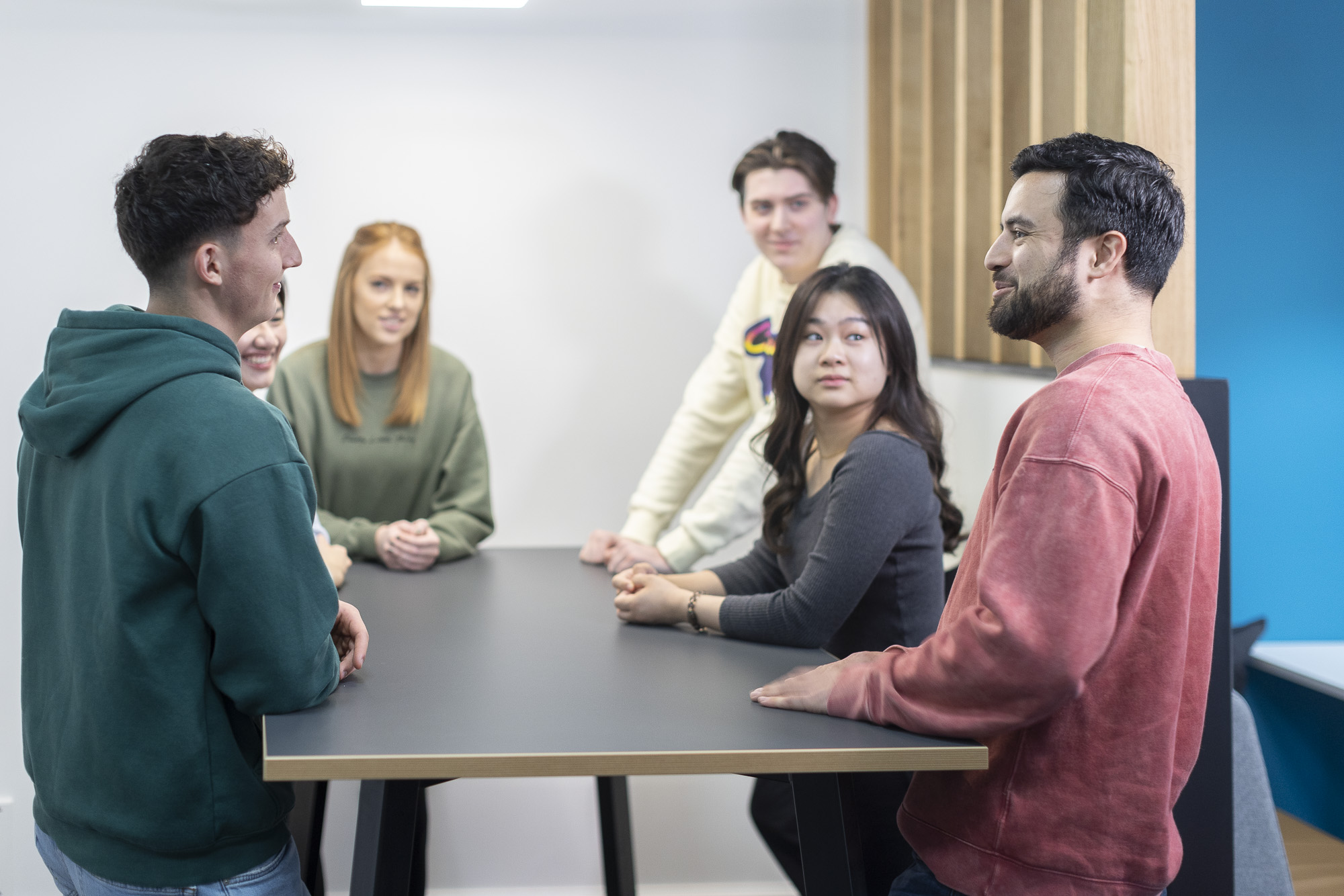 Students discussing a topic around a table