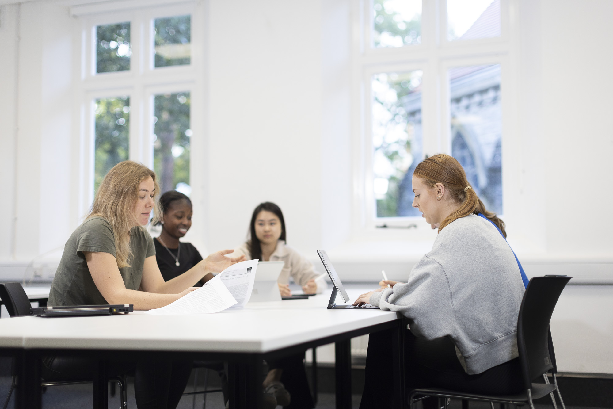 Students looking at paperwork in class