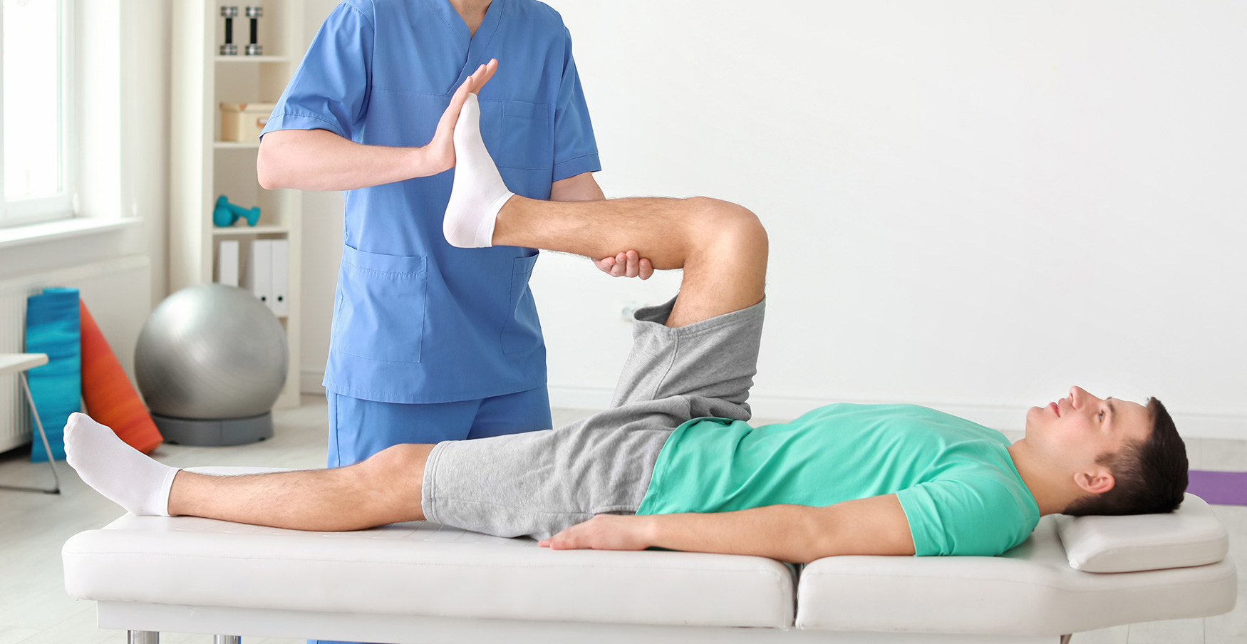 an Osteopath works with a patient